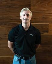 A person in a blue shirtDescription automatically generated